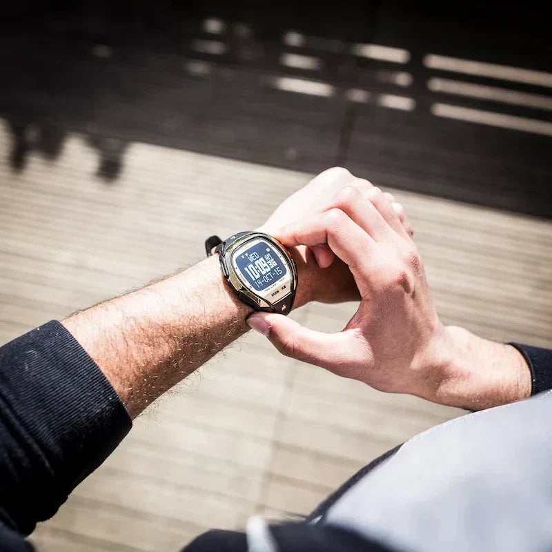 person with sport watch clicking button on watch