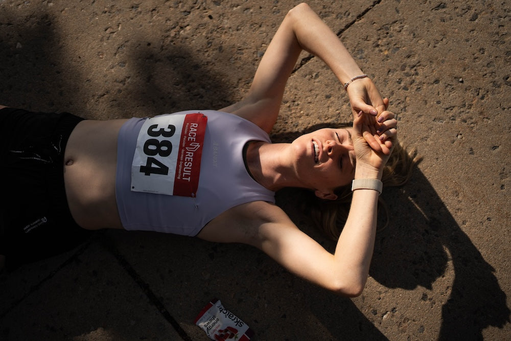 runner laying on ground after a race 