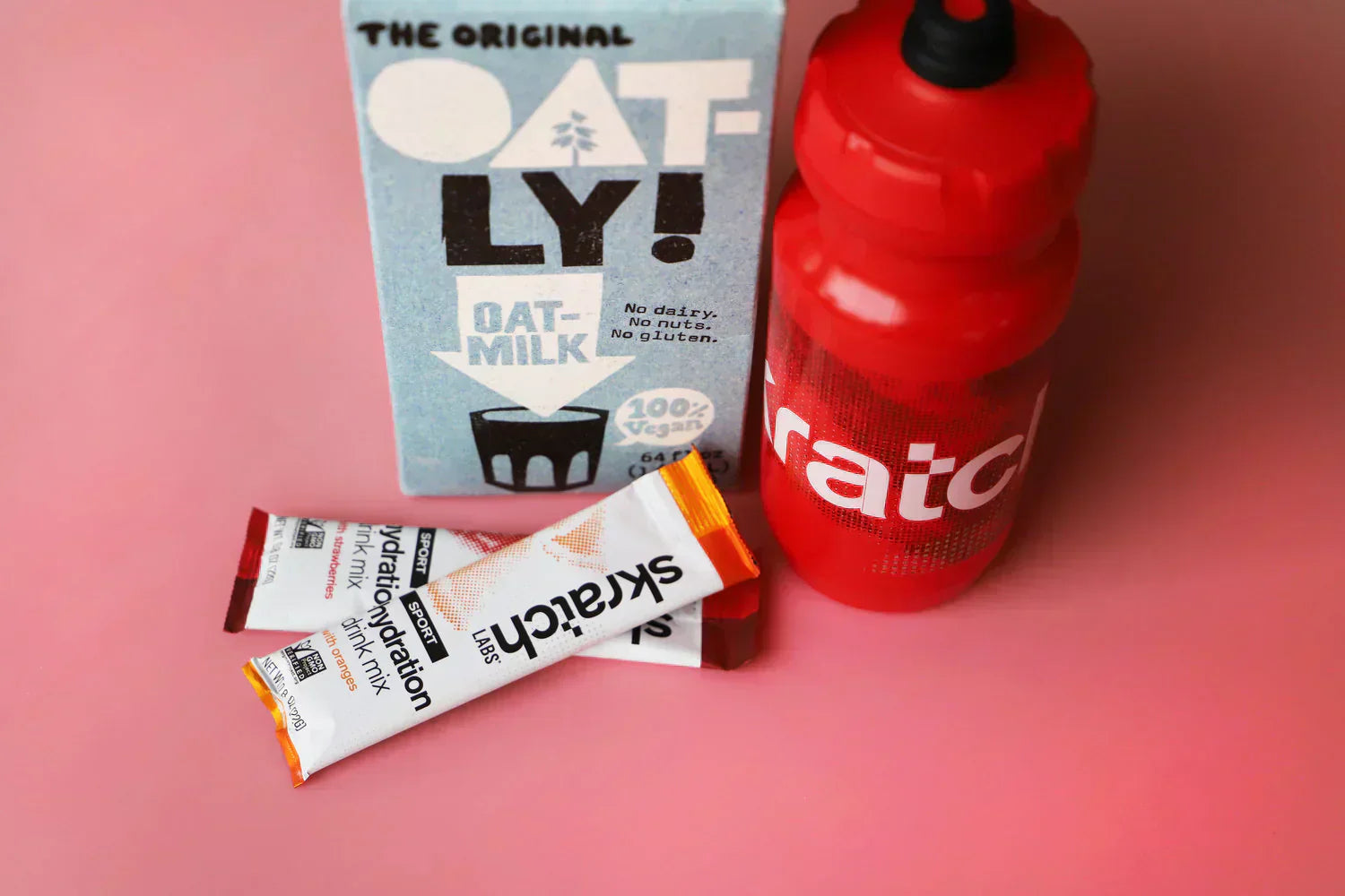oatly bottle with water bottle and hydration packets