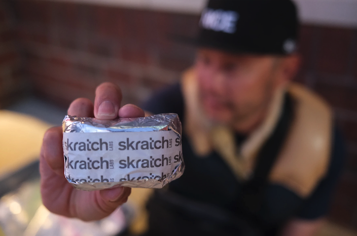 allen lim holding up a wrapped rice cake